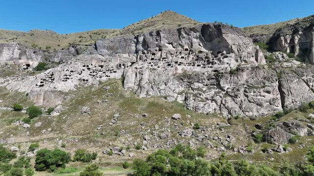 Aerial view of Vardzia - ancient city complex and cave monastery, carved into Erusheti rocky mountain in Georgia. UNESCO World Heritage tentative list.