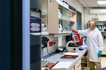 Scientist organizing materials in a modern laboratory.