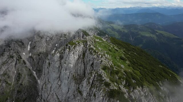 Grosser Donnerkogel, gorgeous mountain peak covered with clouds, Austria, 4k