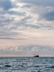 Fishing boat at dramatic sunset on Black Sea coast