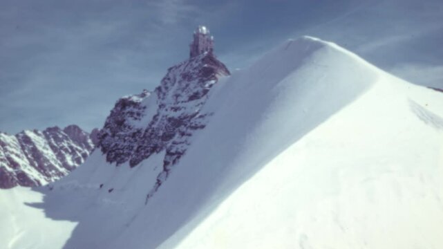 Sphinx Observatory at Jungfraujoch, perched high in the Swiss Alps near Lauterbrunnen. A stunning scene showcasing science and nature in harmony. Color 4K archival footage.