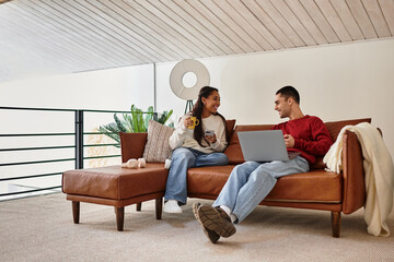 A beautiful couple enjoys each other's company while relaxing in their stylish winter attire.