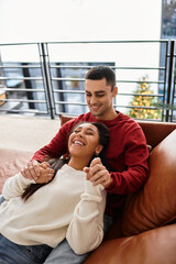 Fototapeta premium A couple enjoys each other's company, embracing warmth and love in cozy winter attire.