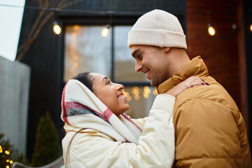 Beautiful couple enjoys each other's company outdoors surrounded by festive decorations.