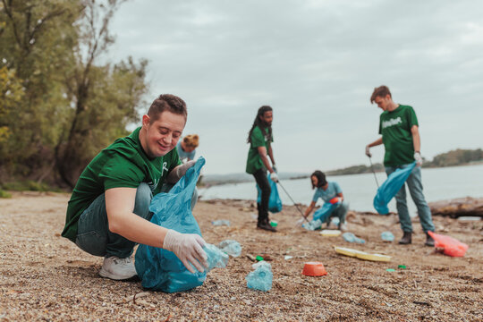 Volunteers collecting plastic waste on river bank: cleaning polluted beach