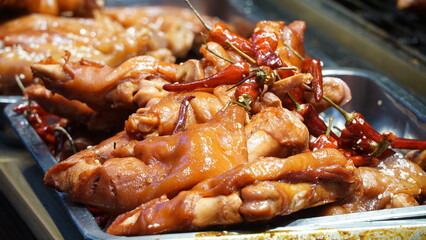 Deliciously grilled Chinese pork trotters, with a golden-brown crispy skin and tender, juicy meat. A savory street food delicacy, seasoned with aromatic spices, traditional Chinese cuisine.