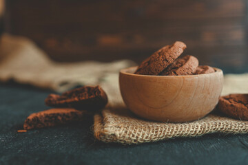 Homemade cookies in a wooden plate, background