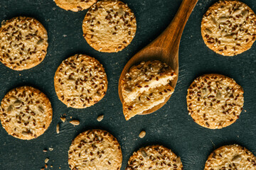 Wooden spoon with homemade cookies with siftings and flax