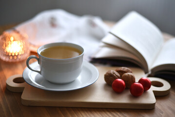 Cup of tea and book on a wooden table moment for reading
