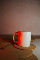 White cup with cork coasters on a light background