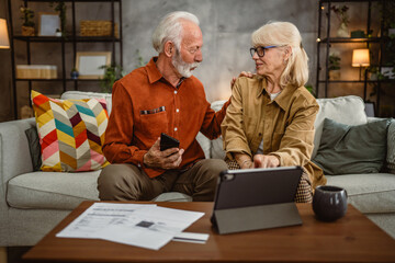 Senior couple do contactless payment and control bills on tablet