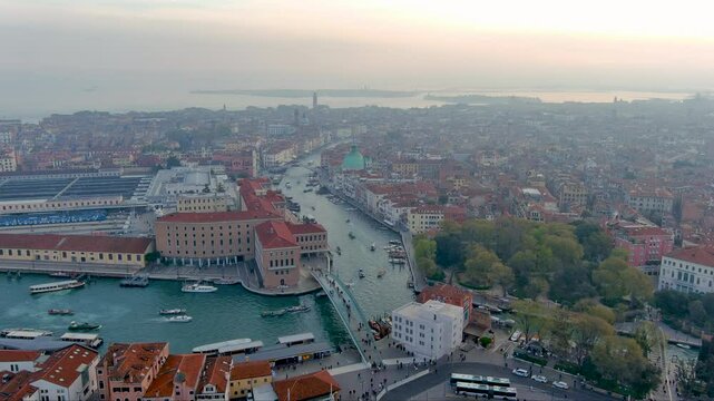Stunning aerial footage of Venice's Grand Canal at sunrise. Captures historic architecture, iconic waterways, and serene cityscape ideal for travel, cityscape, and cinematic visuals.