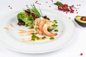 A delicious dish with tender shrimp, avocado and fresh greens. A healthy dinner.