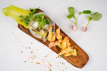 Fresh shrimp tempura. A delicious portion of shrimp tempura garnished with fresh vegetables. Top view. Healthy dinner.