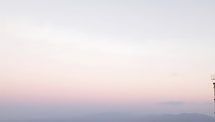 The sky appears as a soft, pale hue reminiscent of pastel colors when viewed from a distant location._00003_