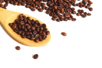  On a white background lies a wooden spoon with coffee beans.