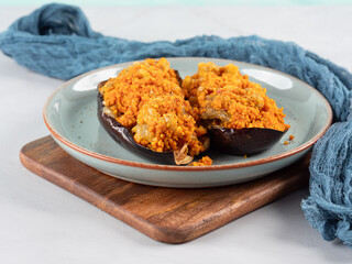 Baked eggplants stuffed with corn couscous with chickpea sauce