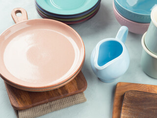 Set of pastel pink, blue color tableware on turquoise background