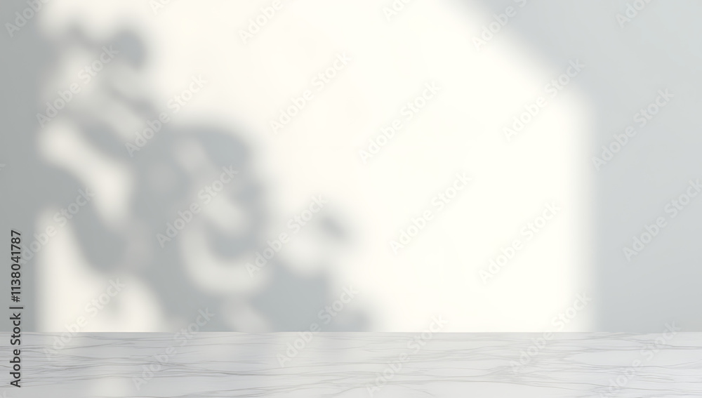 Poster marble table top has a blurred shadow of a tree behind it against a clean white wall background._000