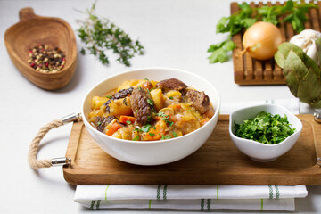 Slow cooked beef stew with potatoes, carrots and onions