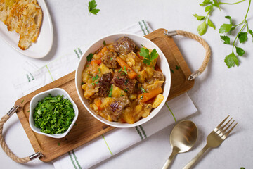 Slow cooked beef stew with potatoes, carrots and onions. View from above, top studio shot