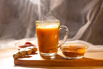Immunity drink with turmeric powder. Turmeric tea. Trendy healthy drink with curcuma spices. Herbal beverage for health and normal bowel function