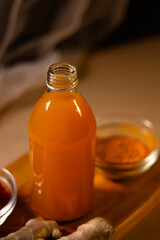 Immunity drink with turmeric powder in bottle to go. Turmeric tea. Trendy healthy drink with curcuma spices. Herbal beverage for health