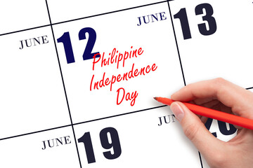 June 12. Hand writing text Philippine Independence Day on calendar date. Save the date.
