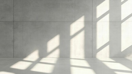 Obraz premium Minimalist concrete interior with natural light creating geometric shadows on the wall, ideal for modern design themes.