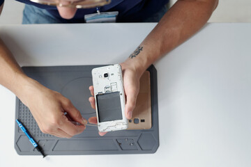 Repairing Smartphone on Work Desk Using Tools
