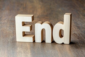 Wooden letters spelling the word End on a rustic surface, symbolizing completion and finality in various contexts.