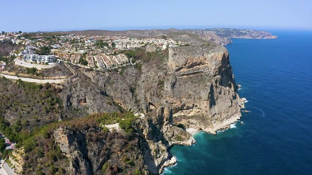 Aerial view of the wonderful Cala del Moraig and Cala de los Tiestos, located between the beautiful cliffs of the town of Benitachell, in the Mediterranean province of Alicante, Spain.