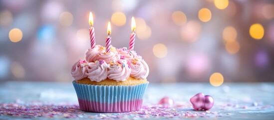 Festive cupcake with candles on a blurred background perfect for celebration greeting cards and birthday invitations