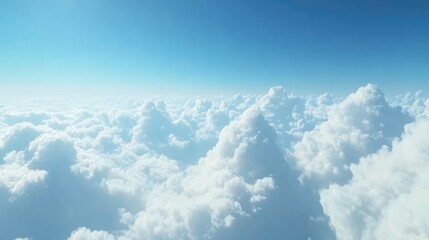 Expansive view of fluffy white clouds against a serene blue sky depicting tranquility and the beauty of nature's sky scape.