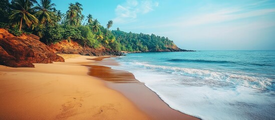Obraz premium Serene coastline of Kerala featuring lush greenery, sandy beaches, and gentle waves under a clear blue sky. Perfect tropical getaway scene.