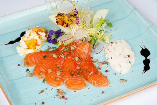 Fresh salmon fillet. Delicious portion of salmon fillet with aromatic herbs and elegant serving. Healthy dinner.