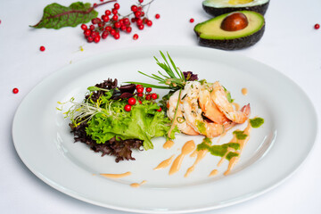 A delicious dish prepared with tender shrimp, avocado and fresh greens. A healthy dinner.