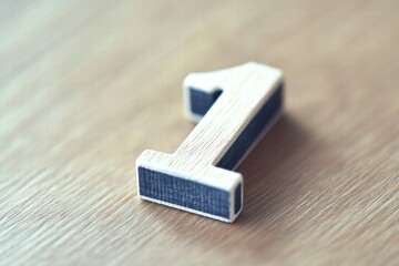 Stylish wooden number one on a wooden surface, perfect for showcasing themes of achievement and beginnings.