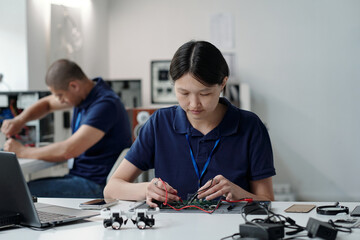 Focused Engineer Soldering Circuit Board in Lab Setting