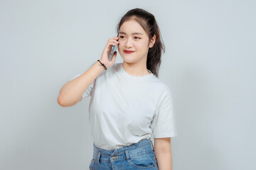 A portrait of a cheerful Asian woman directing the phone to his ear, meaning he was making a call