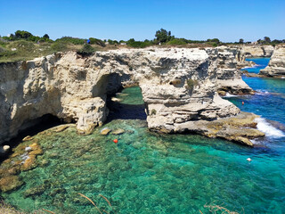 Faraglioni of Sant’Andrea, Melendugno, Lecce, Puglia, Italy. Eroded karst cliffs in an inviting...