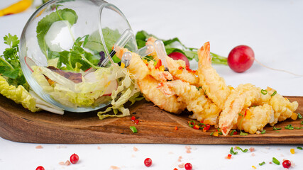 Fresh shrimp tempura. A delicious serving of shrimp tempura garnished with fresh vegetables. Healthy dinner.