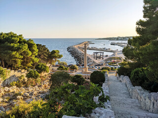 Littoral of Santa Maria di Leuca with the monumental staircase (Cascata Monumentale begun in 1906), part of the Apulian aqueduct with a Roman column, Lecce, Puglia (Apulia), Italy.