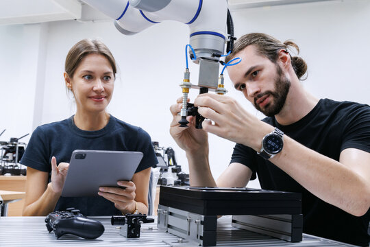 automation machine engineer students study and inspection control robot arm machine in robotics engineering academy at university or factory workshop. AI robot technology, future innovation trend.