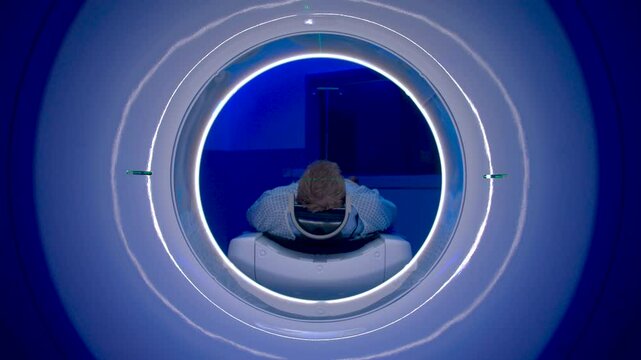 CT Scanner. Patient receiving a computed tomography brain scan.