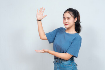 Shock Asian beautiful girl point beside her in white background