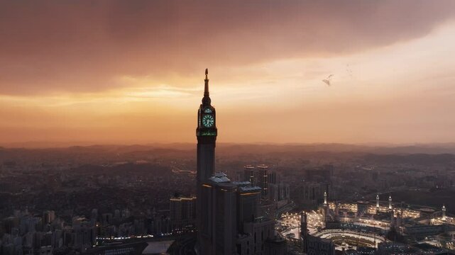 Aerial time lapse view showing crowds of pilgrims gathered around the Kaaba in the Grand Mosque, with construction cranes surrounding the site in Mecca