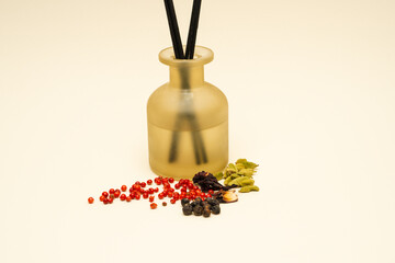 An elegant decorative oil bottle, beautifully designed and filled with spices and sticks