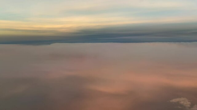 A pilot&rsquo;s perspective POV FPV flying over golden color stratus clouds at sunrise. Aerial footage taken from a jet cokpit. 4K 60FPS