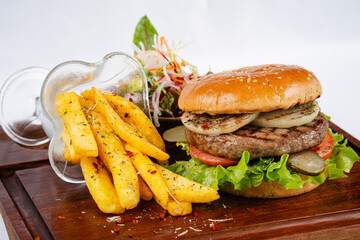 Delicious homemade grilled beef burger. Burger served with fries and salad.